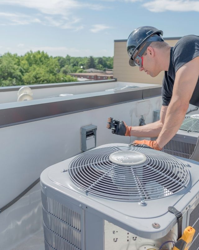 Hvac Tech working on Condensing Unit